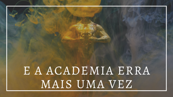 Audiodescrição resumida: foto de dois livros em cima de uma mesa. Estatueta do oscar em meio à fumaça. à frente da foto, em letras brancas, e a academia erra mais uma vez..